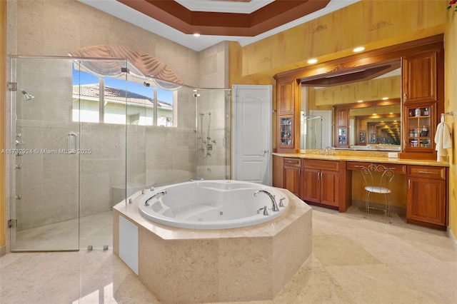 bathroom featuring a jetted tub, a shower stall, ornamental molding, and vanity