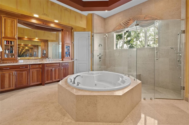 full bath featuring a tub with jets, a stall shower, and vanity