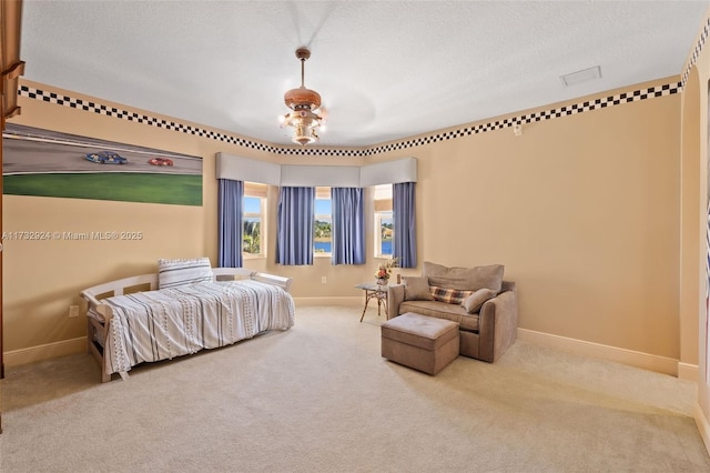 bedroom with carpet, a textured ceiling, and baseboards