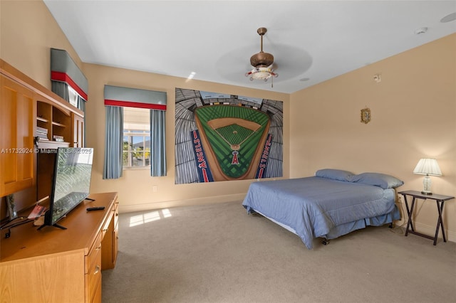 bedroom with light carpet, baseboards, and a ceiling fan