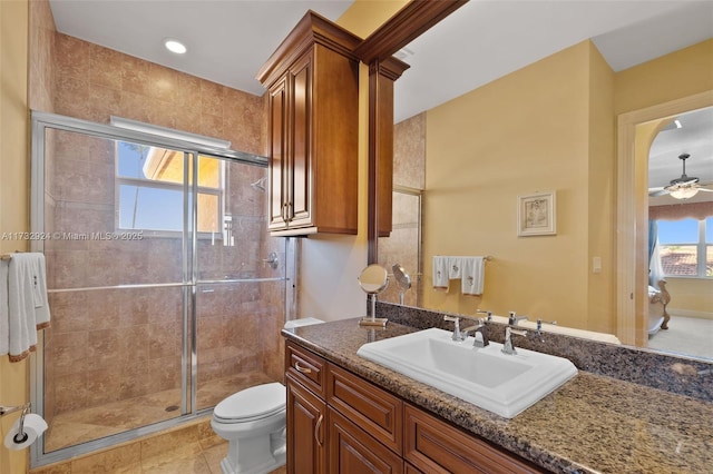 full bathroom featuring toilet, ensuite bath, ceiling fan, vanity, and a shower stall