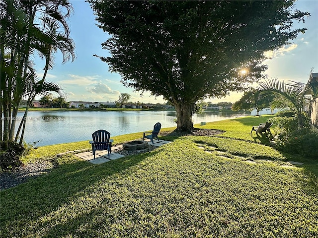 view of yard featuring a water view and a fire pit