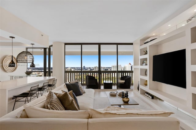 living room featuring built in features, a wealth of natural light, and expansive windows