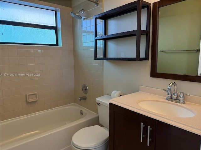 bathroom with washtub / shower combination, vanity, and toilet