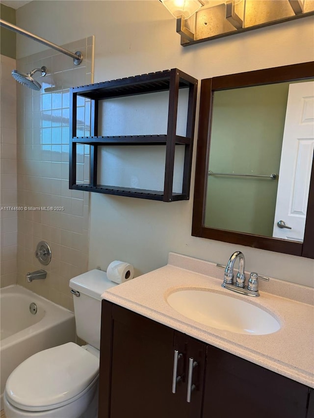 bathroom featuring toilet, shower / bathing tub combination, and vanity