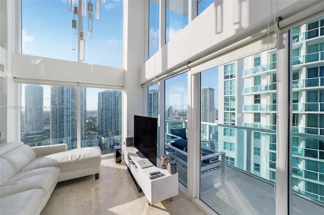 living area with a towering ceiling