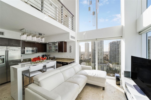 living room with a high ceiling and visible vents