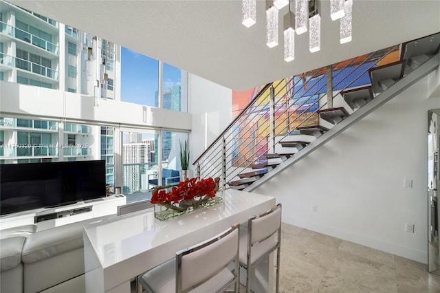 interior space featuring a view of city, baseboards, and stairs