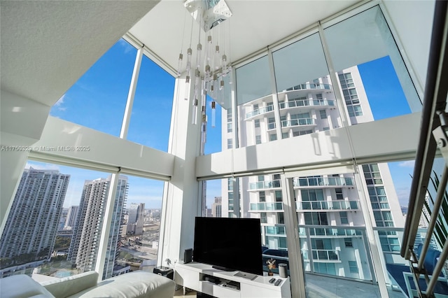 living room featuring a towering ceiling and a chandelier