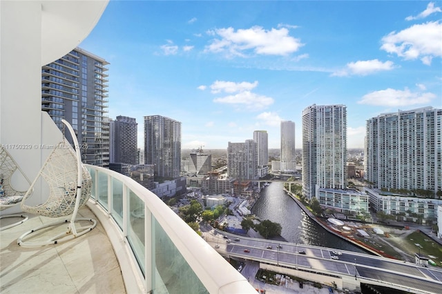 balcony with a view of city and a water view