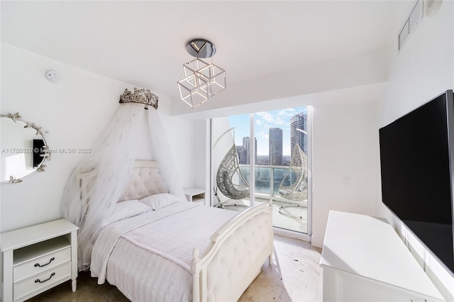 bedroom featuring access to exterior, visible vents, and a chandelier