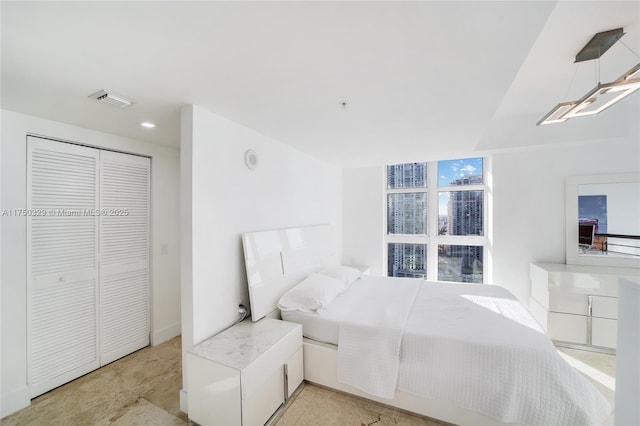 bedroom with a closet and visible vents