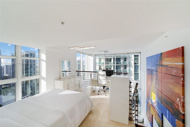 bedroom with floor to ceiling windows and a city view