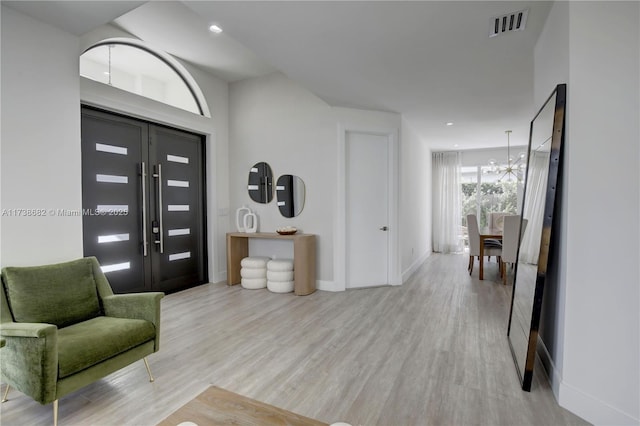 foyer with a notable chandelier, recessed lighting, visible vents, baseboards, and light wood-style floors