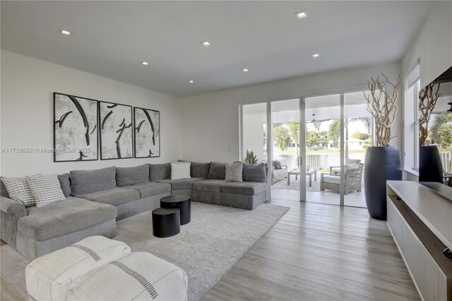 living area with recessed lighting and light wood-style flooring