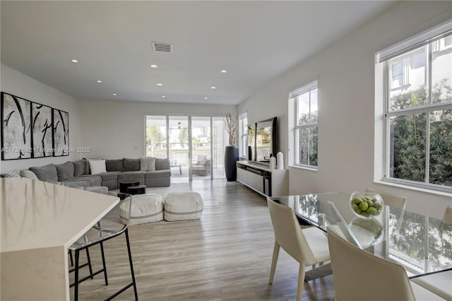 dining room featuring light wood finished floors, visible vents, and recessed lighting