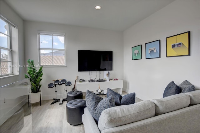 living room with recessed lighting, baseboards, and wood finished floors