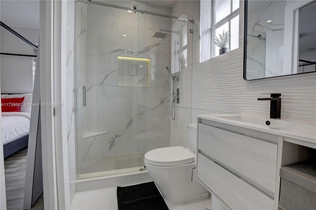 bathroom featuring a marble finish shower, toilet, ensuite bath, vanity, and tile walls