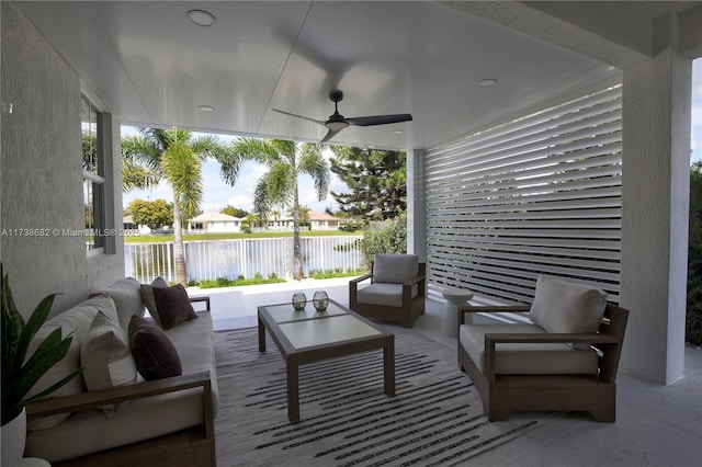 view of patio with an outdoor hangout area, ceiling fan, a water view, and fence