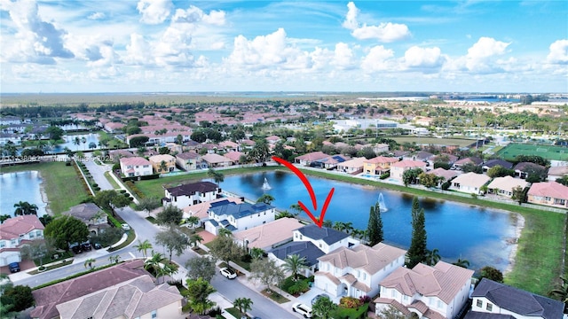 birds eye view of property featuring a water view and a residential view