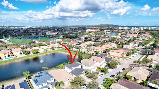 bird's eye view with a residential view and a water view