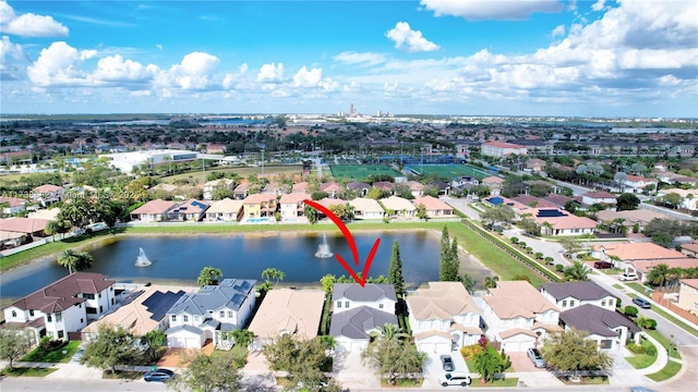 bird's eye view featuring a water view and a residential view