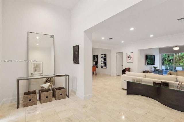 living area with ornamental molding, recessed lighting, visible vents, and baseboards