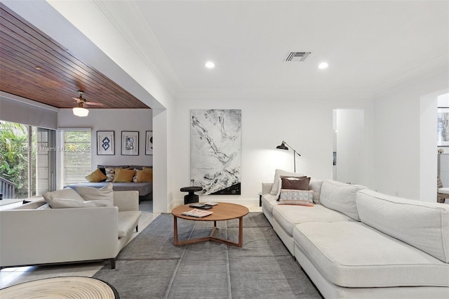 living area featuring recessed lighting, visible vents, and crown molding