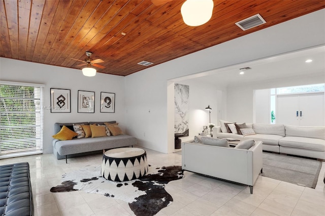 living area featuring a ceiling fan, wooden ceiling, visible vents, and light tile patterned floors