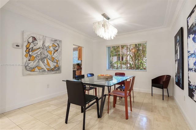 dining space featuring a chandelier, baseboards, and crown molding