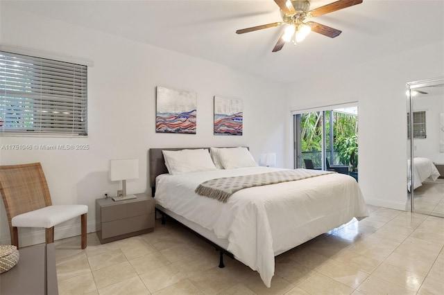 bedroom featuring light tile patterned floors, baseboards, and a ceiling fan