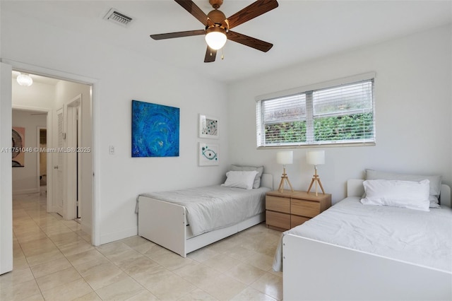 bedroom with visible vents, ceiling fan, baseboards, and light tile patterned flooring