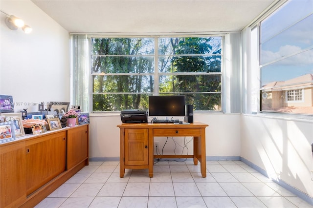 office area with light tile patterned floors and baseboards