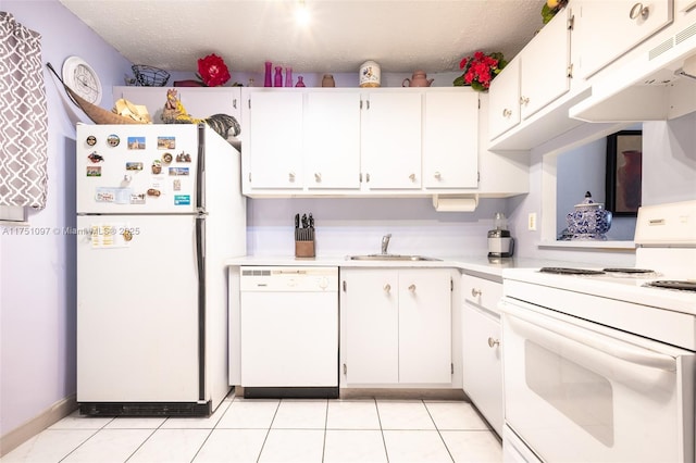 kitchen with light countertops, white appliances, white cabinets, and a sink