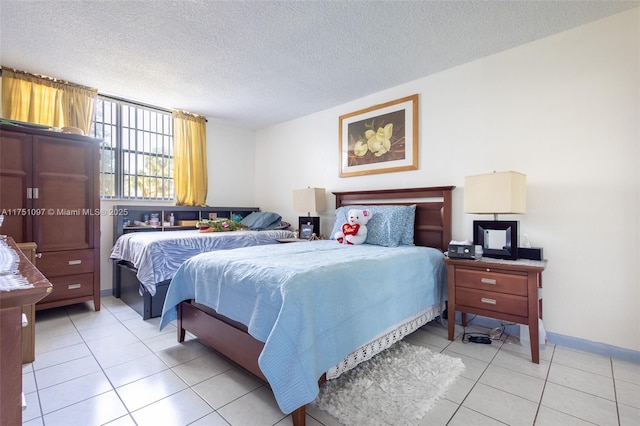 bedroom featuring a textured ceiling, light tile patterned flooring, and baseboards