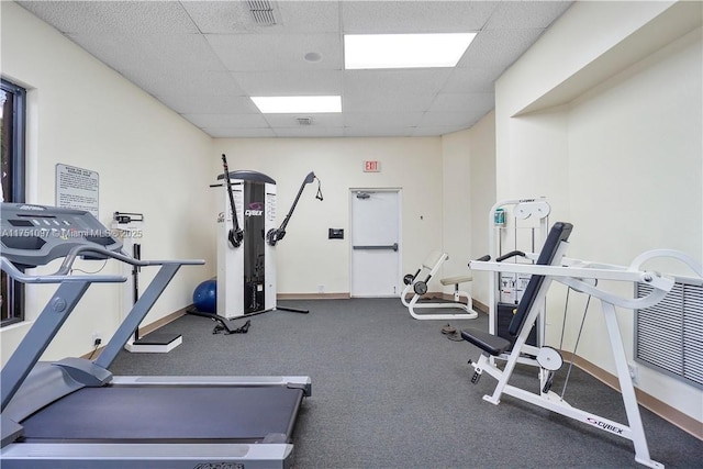 gym featuring a drop ceiling, visible vents, and baseboards