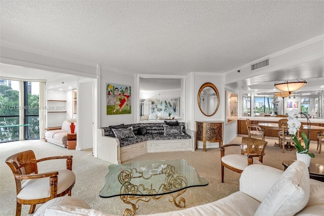 living area with baseboards, visible vents, a textured ceiling, and light colored carpet