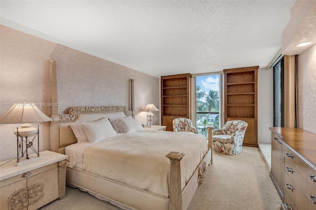 bedroom featuring a textured ceiling and light colored carpet