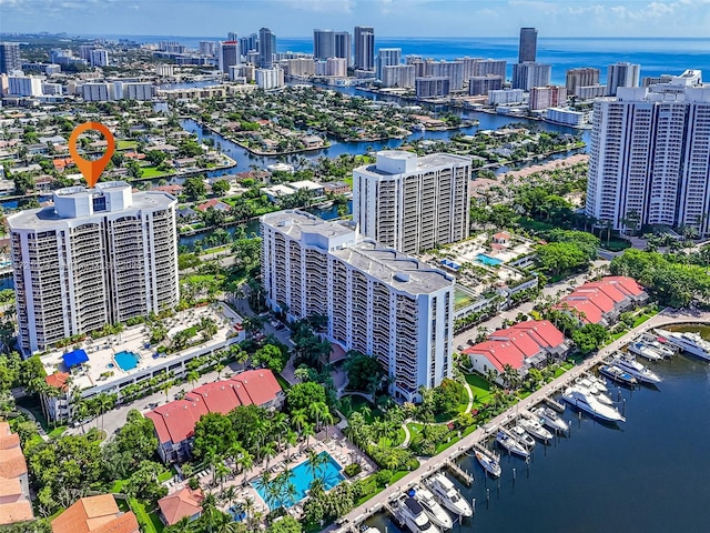 birds eye view of property with a water view and a city view