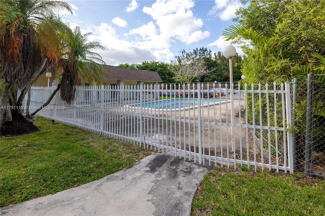 view of pool with a yard, fence, and a fenced in pool