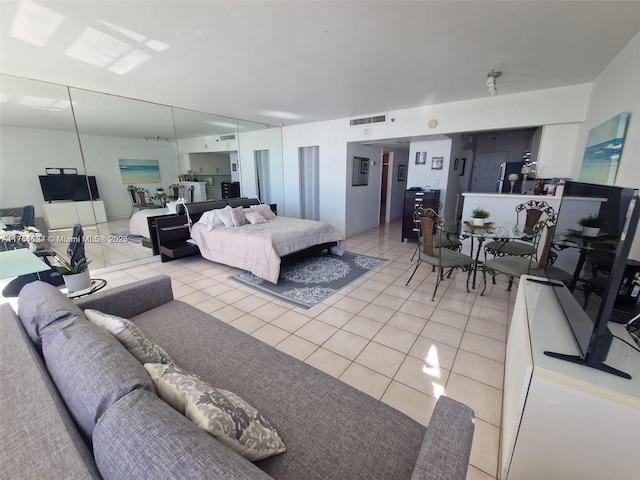 bedroom with light tile patterned floors and visible vents