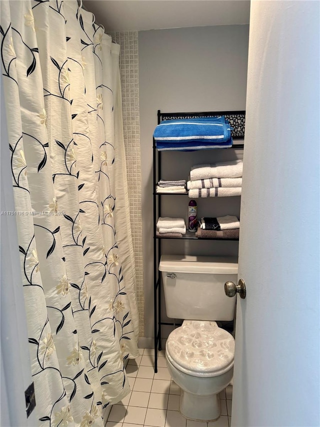 full bath with toilet and tile patterned floors