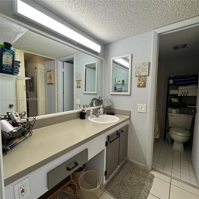 9200 Lime Bay Blvd Unit 212, Tamarac, FL 33321 - bathroom featuring vanity, tile patterned flooring, a textured ceiling, and toilet
