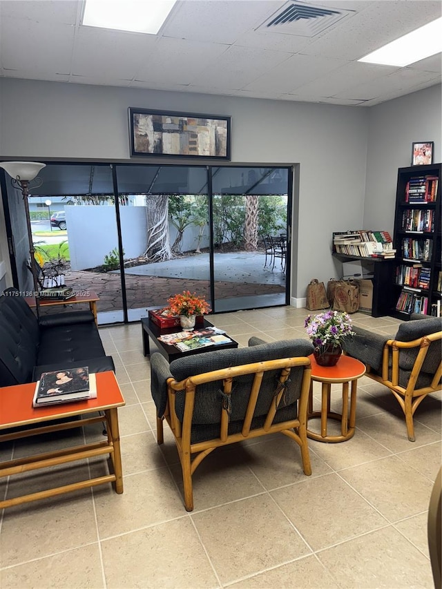 9200 Lime Bay Blvd Unit 212, Tamarac, FL 33321 - living area featuring visible vents, tile patterned flooring, and a drop ceiling