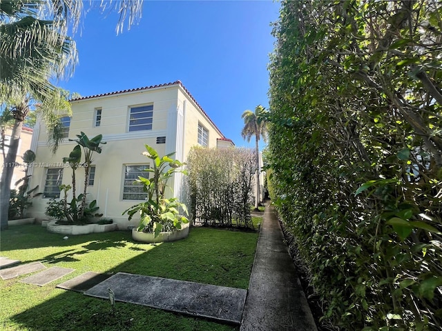 view of property exterior with a yard and stucco siding