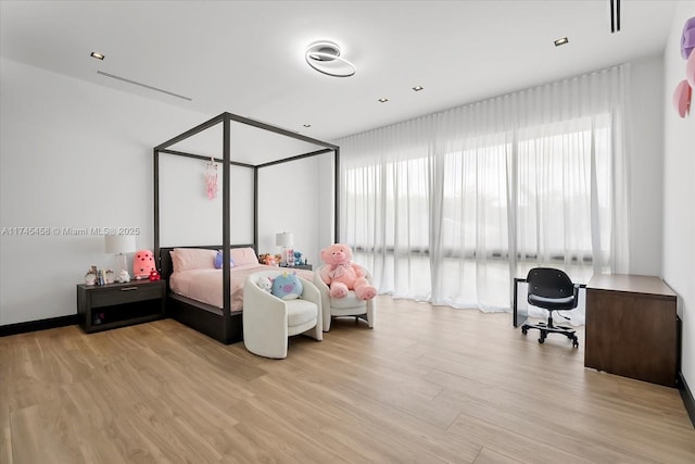 bedroom with light wood-type flooring