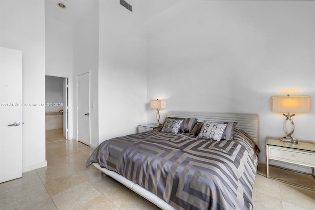 bedroom with visible vents, a towering ceiling, and light tile patterned floors