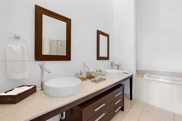 full bath featuring double vanity, a garden tub, a sink, and tile patterned floors