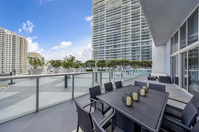 balcony with a city view and outdoor dining space