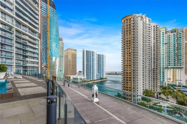 balcony featuring a view of city and a water view